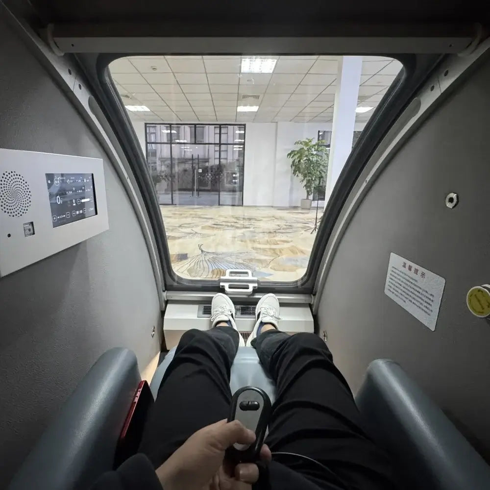 Interior view of the KOMJET Whale Cabin 2.0 hyperbaric oxygen chamber with a user relaxed inside.
