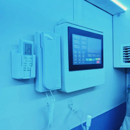 Interior view of the KOMJET Anti-Aging Cabin 2.0 showing control panel and intercom system.